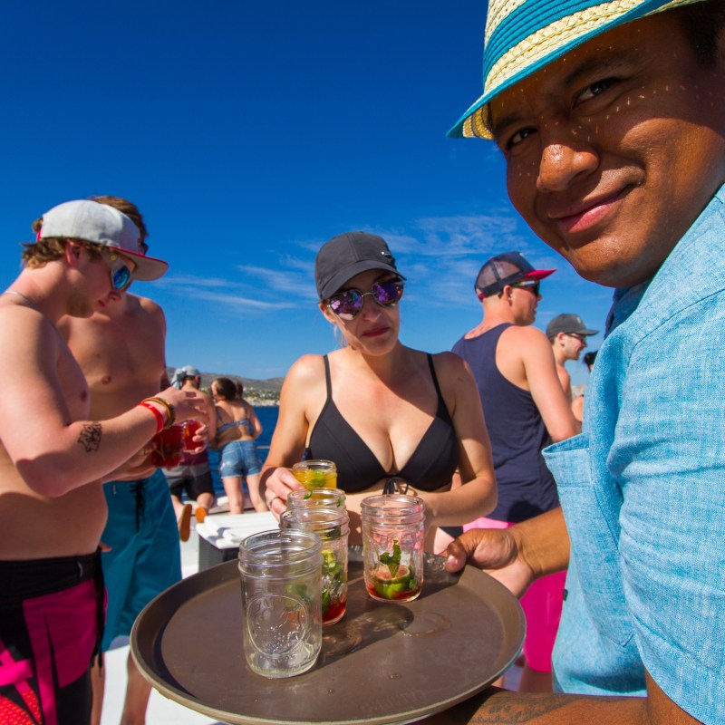 a waiter serving drinks to people on a boat