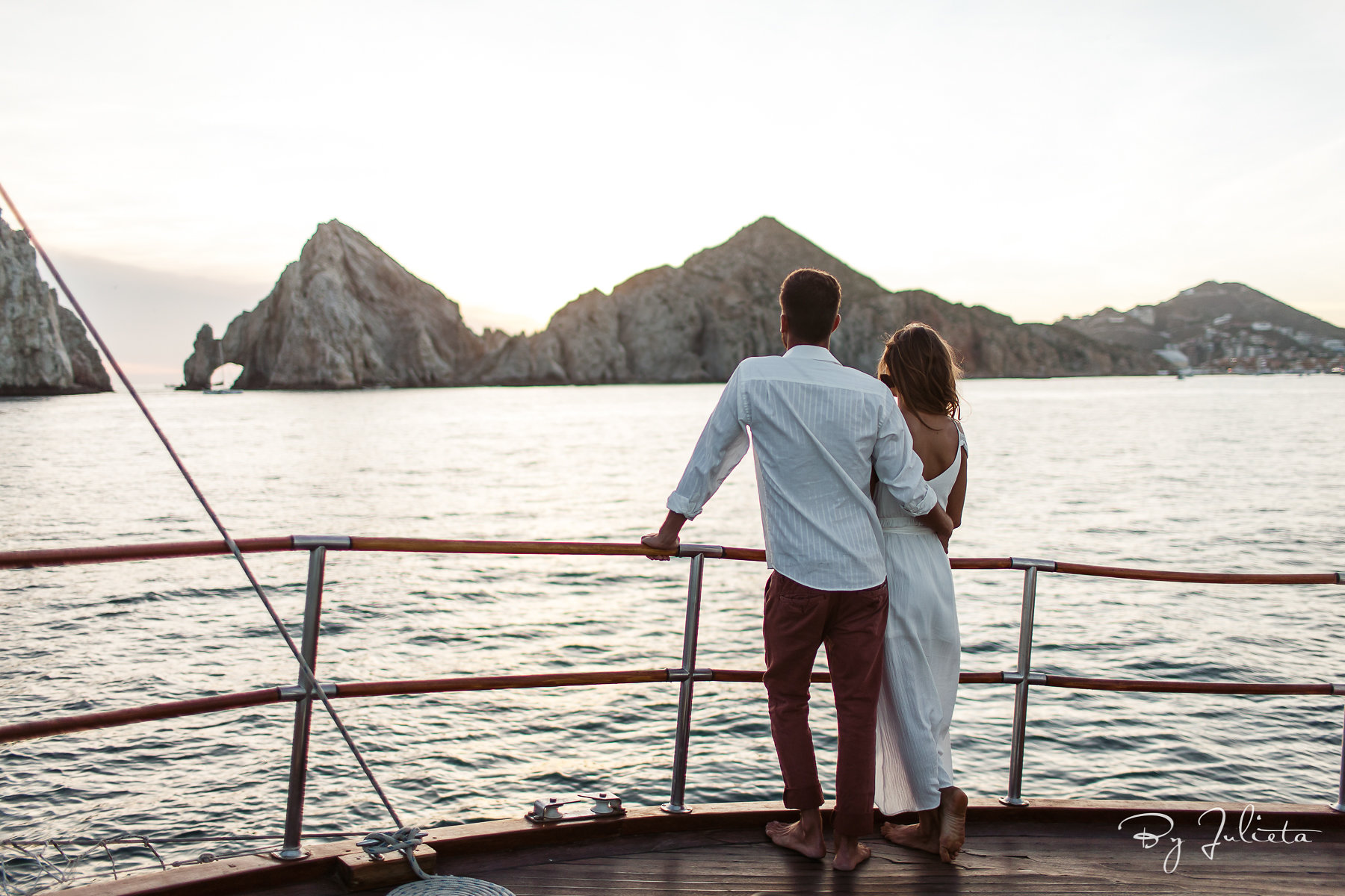 WildCaboTours – Tu Enamorado 4 a couple standing on a boat next to a body of water