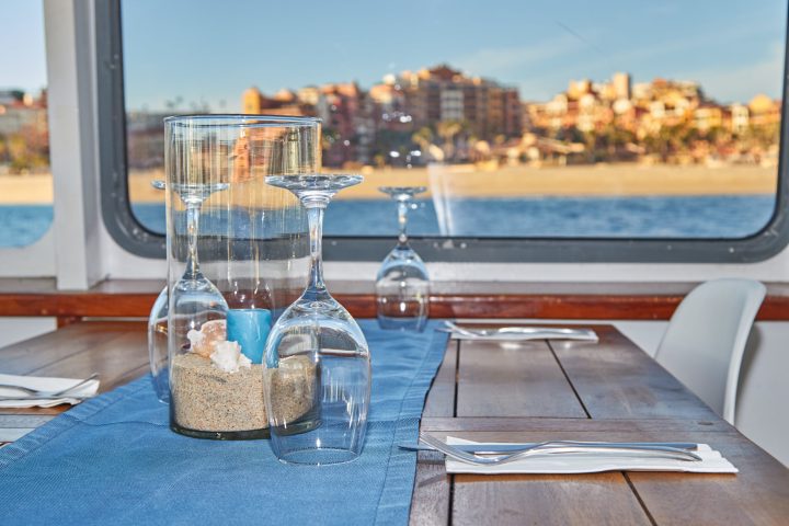 a glass of water on a table on a boat