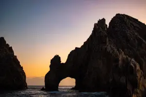 a large body of water with a mountain in the background