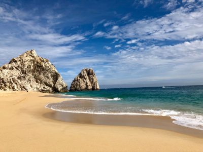 a sandy beach next to the ocean