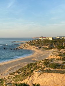 a sandy beach next to a body of water