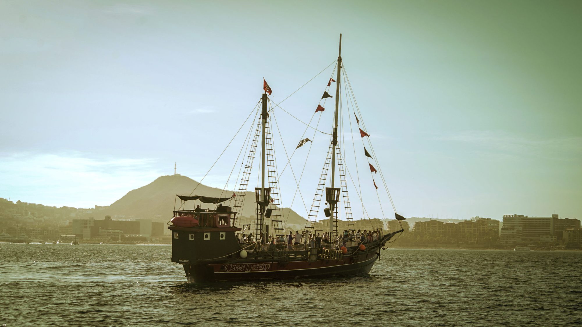WildCaboTours – Guacamole 5 a ship over a body of water