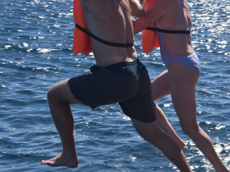 a woman standing next to a body of water
